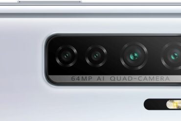 silver Huawei P40 lite 5G laying on its side, showcasing the quad camera setup