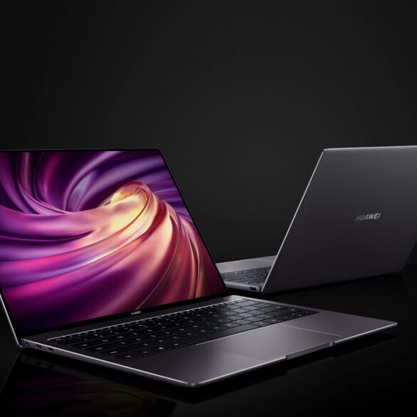 Two open Huawei laptops against a dark background