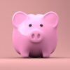 Pink piggy bank against a pink background