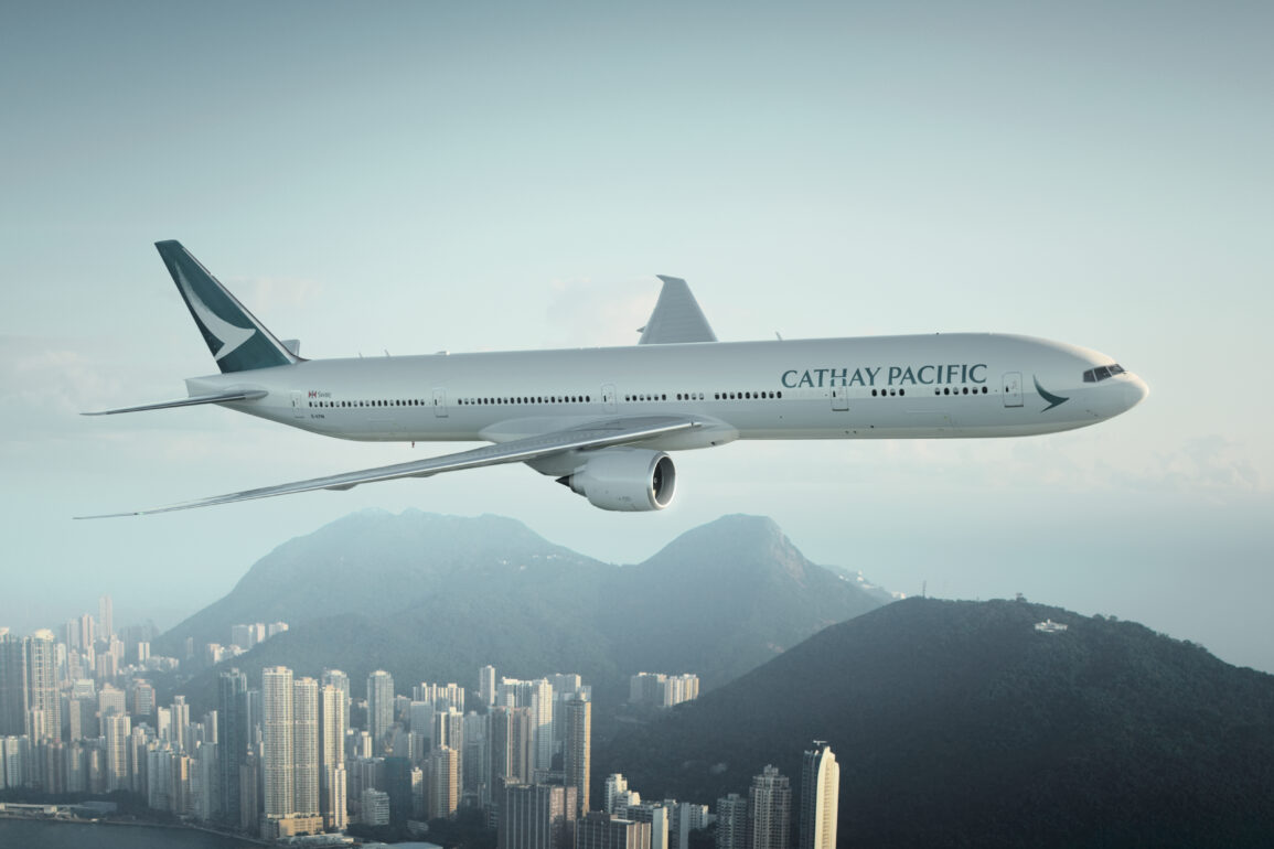 Cathay Pacific aircraft flying above a city