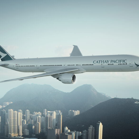 Cathay Pacific aircraft flying above a city