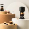 Nespresso Vertuo system and various coffee mugs filled with coffee