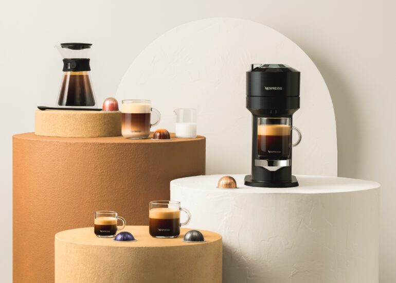 Nespresso Vertuo system and various coffee mugs filled with coffee