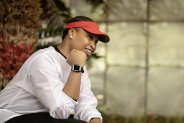 Picture of a person sitting oustide showing off the Vodacom Linea smartwatch on their wrist