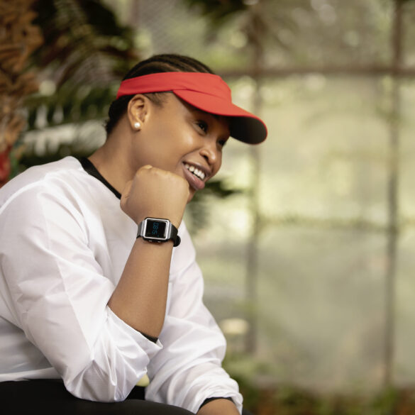 Picture of a person sitting oustide showing off the Vodacom Linea smartwatch on their wrist