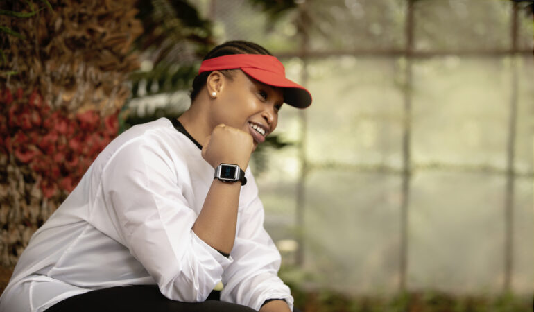 Picture of a person sitting oustide showing off the Vodacom Linea smartwatch on their wrist