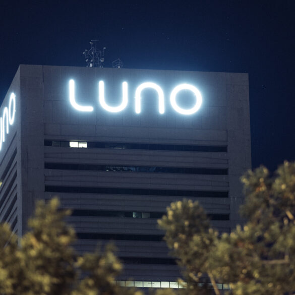 Night time image of LUNO sign on building