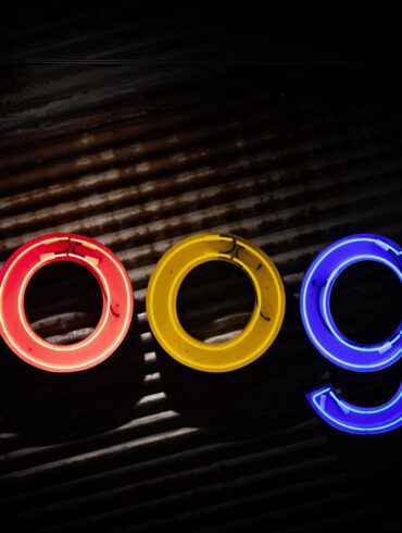 Image of the Google logo in neon lights against a dark background