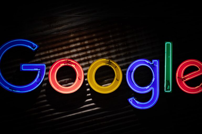 Image of the Google logo in neon lights against a dark background