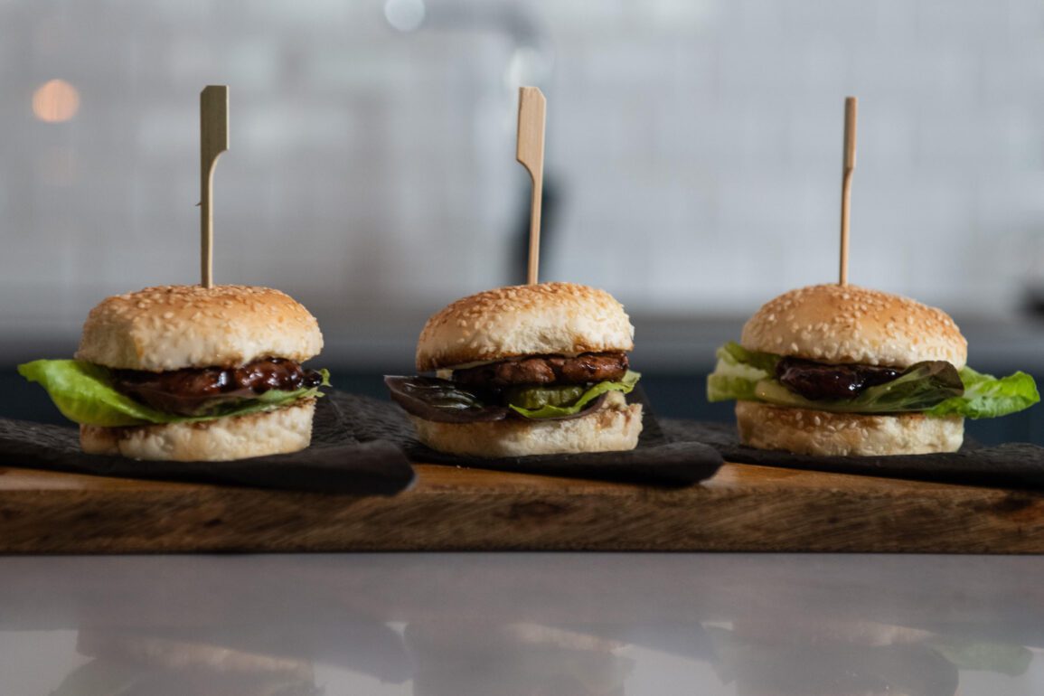 Picture of three Mzansi Meat Co burgers lined up next to each other