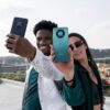 Product image of a man and a woman holding the Huawei nova Y90 outside