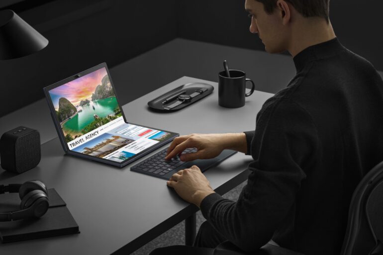 product image of the ASUS Zenbook Fold laptop being used in its folded position on an office desk setup