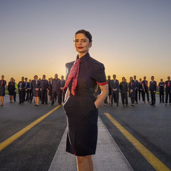 Outdoors group image of various staff members of British Airways wearing the company's new uniform.