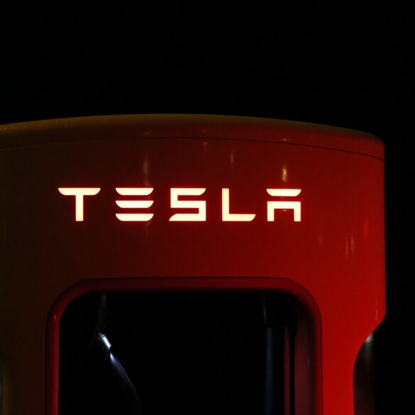 close-up-of-illuminated-text-of-Tesla-supercharger-against-black-background