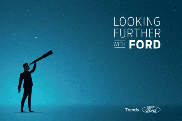 Image of a man holding a looking glass to echo the looking further with Ford tag line