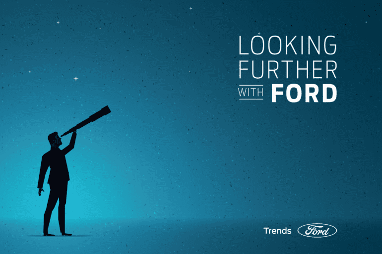 Image of a man holding a looking glass to echo the looking further with Ford tag line