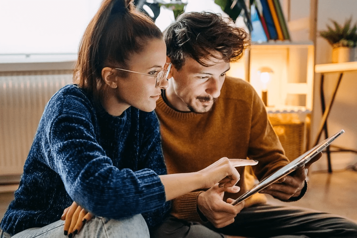 man and woman with tablet being vigilant while browsing Visa site and other online properties