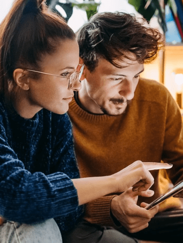 man and woman with tablet being vigilant while browsing Visa site and other online properties