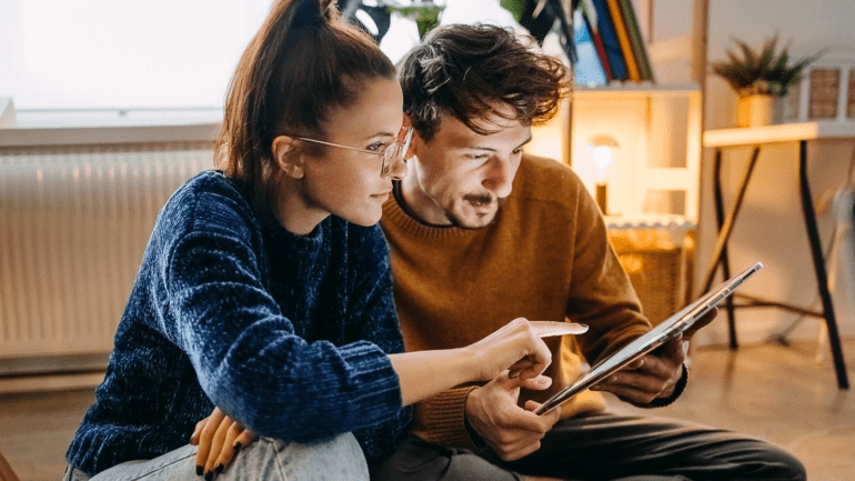 man and woman with tablet being vigilant while browsing Visa site and other online properties